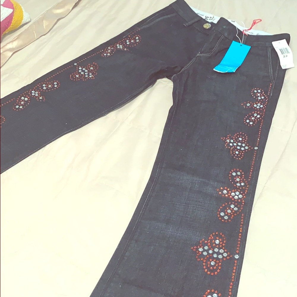 Dark denim jeans with orange and white rhinestones